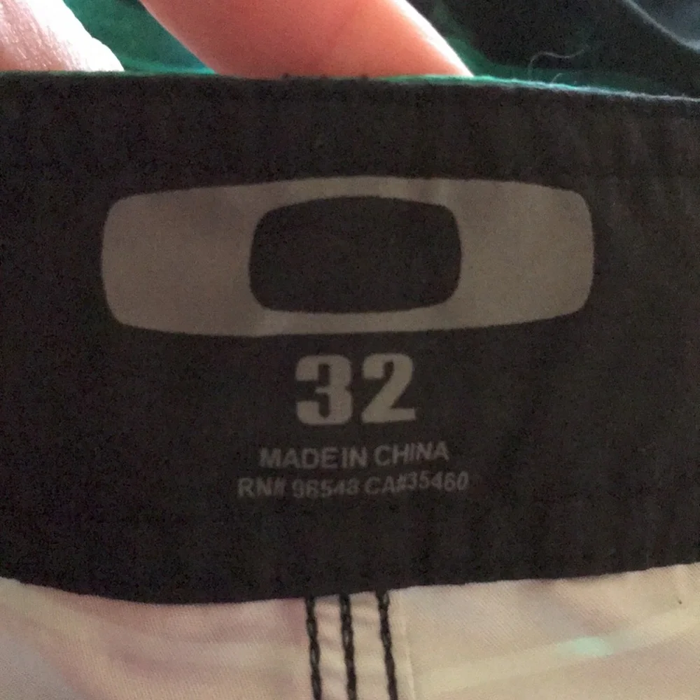 Oakley Origin size 30 x 10.5” black green striped board shorts swim trunks EUC